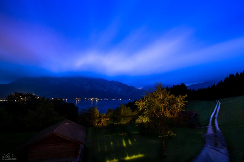 Long exposure photo of blue clouds at night over the Attersee, Austria
