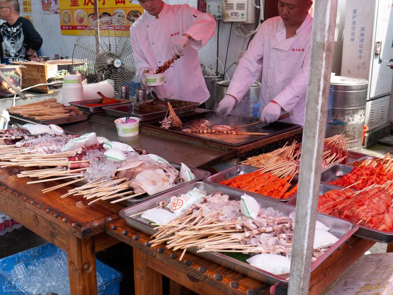 Street food being prepared in a market along the streets of Shanghai